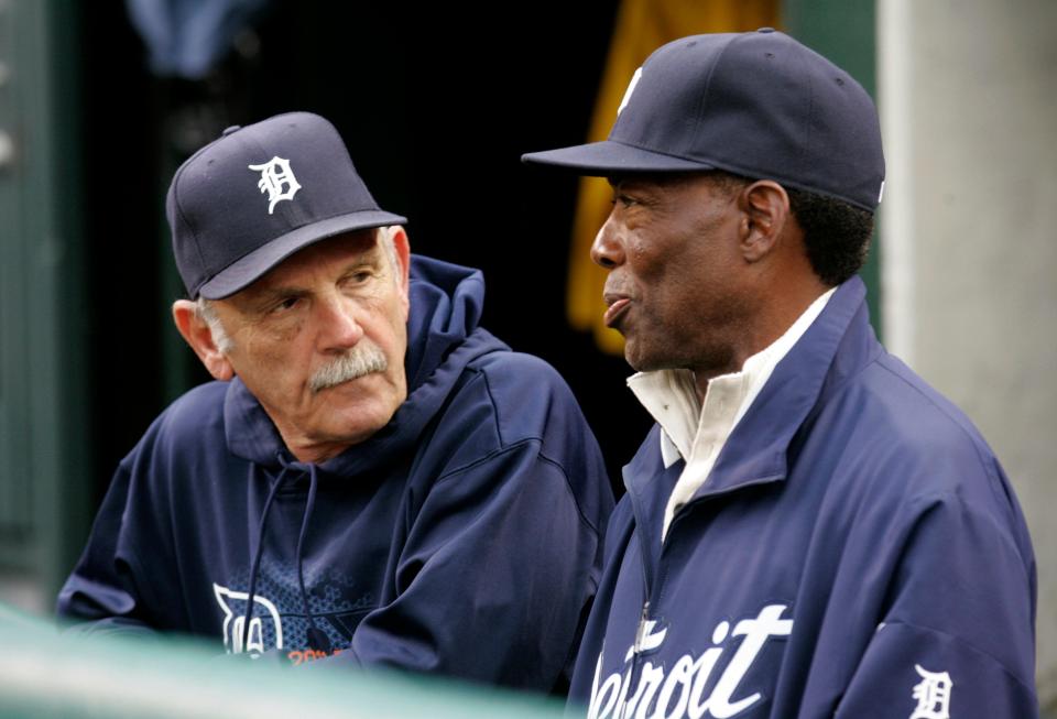 Detroit Tigers manager Jim Leyland (L) speaks with former Tigers' player Chet Lemon in the dugout before the start of play against the Texas Rangers in Game 4 in their MLB American League Championship Series baseball playoffs in Detroit, Michigan, October 12, 2011