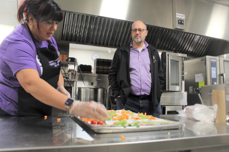 Rep. Gary Click, R-Vickery, listens as Dana Filliater, Croghan Elementary School's cafeteria manager, speaks Nov. 19 as she prepares food before lunch. Click visited the school and Fremont Middle School as part of an effort to shine a spotlight on workforce shortages at Fremont City Schools.