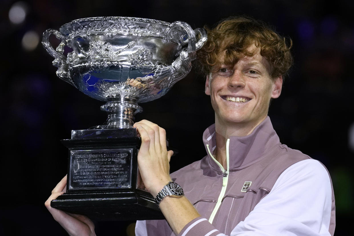 Jannik Sinner of Italy holds the Norman Brookes Challenge Cup aloft after defeating Daniil Medvedev of Russia in the men's singles final at the Australian Open tennis championships at Melbourne Park, in Melbourne, Australia, Sunday, Jan. 28, 2024. (AP Photo/Andy Wong)