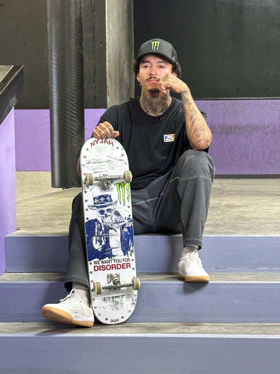 Nyjah Huston poses with his board at his private skate park in San Clemente, Calif., June 12, 2024. Huston is headed back to the Olympics with a determination to improve on his non-medal performance three years ago in Tokyo. (AP Photo/Greg Beacham)