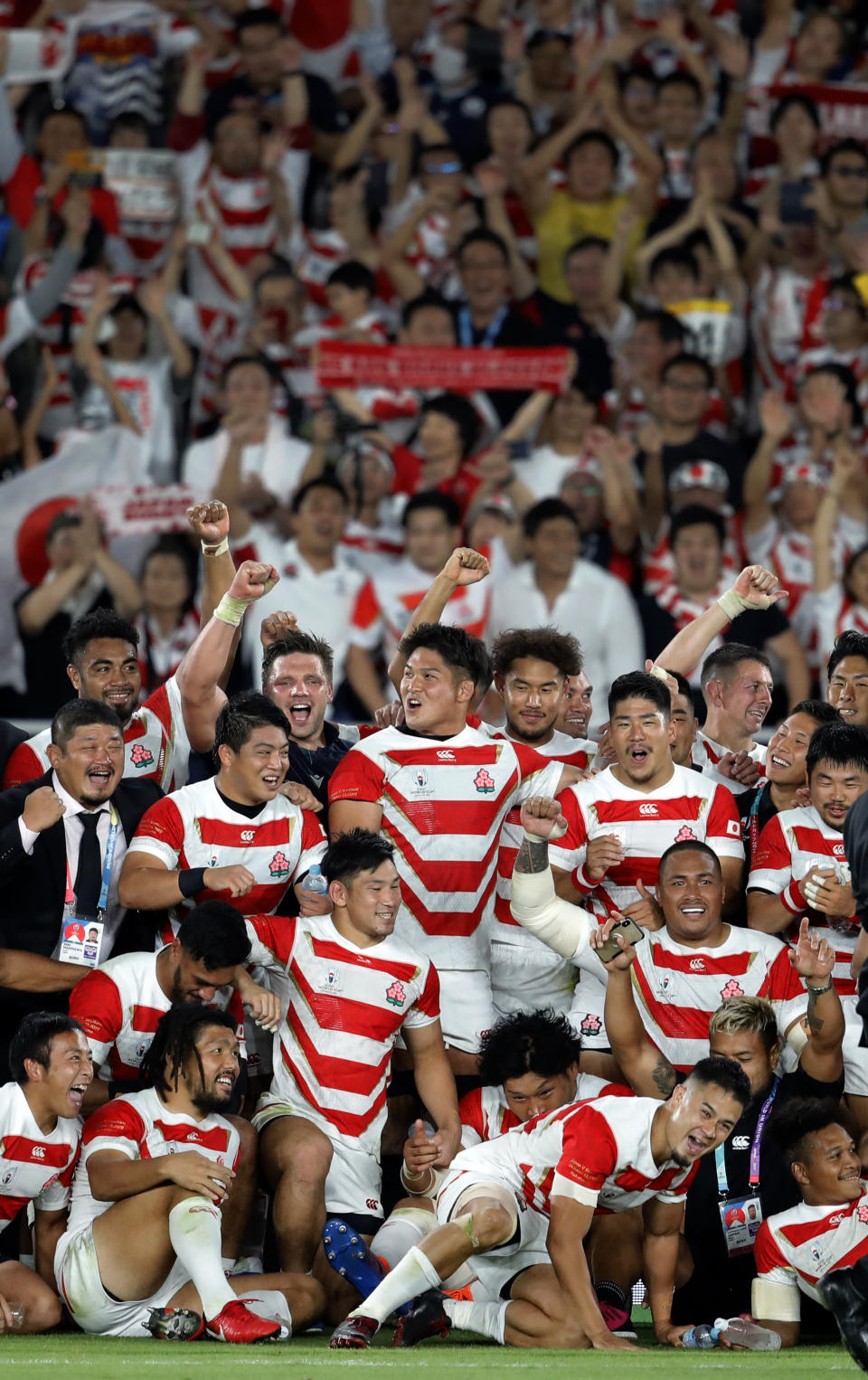 Japan players celebrate after defeating Scotland 28-21 in their Rugby World Cup Pool A game at International Stadium in Yokohama, Japan, Sunday, Oct. 13, 2019. (AP Photo/Christophe Ena)