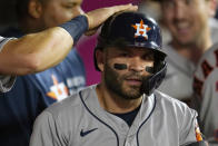 Houston Astros' Jose Altuve gets a pat on his helmet after hitting a two-run home run during the fifth inning of a baseball game against the Los Angeles Angels Tuesday, Sept. 21, 2021, in Anaheim, Calif. (AP Photo/Marcio Jose Sanchez)