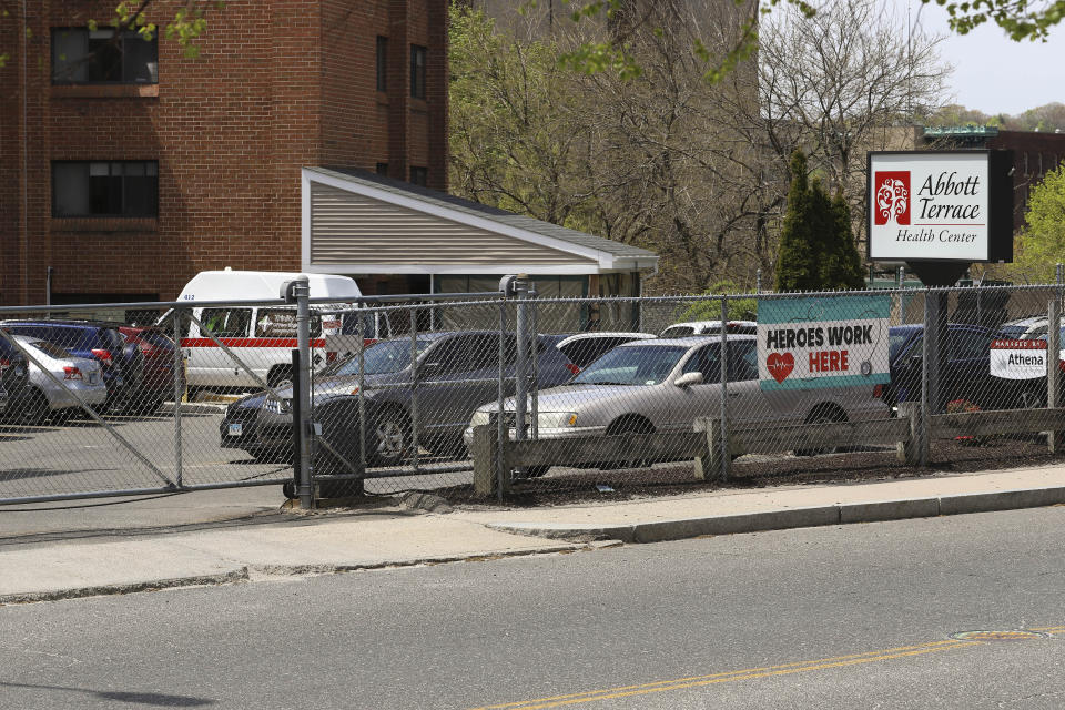 Cars sit parked in an employee parking lot outside the Abbott Terrace Health Center, Thursday, May 14, 2020 in Waterbury, Conn. The coronavirus has had no regard for health care quality or ratings as it has swept through nursing homes around the world, killing efficiently even in highly rated care centers. Preliminary research indicates the numbers of nursing home residents testing positive for the coronavirus and dying from COVID-19 are linked to location and population density — not care quality ratings. (AP Photo/Chris Ehrmann)