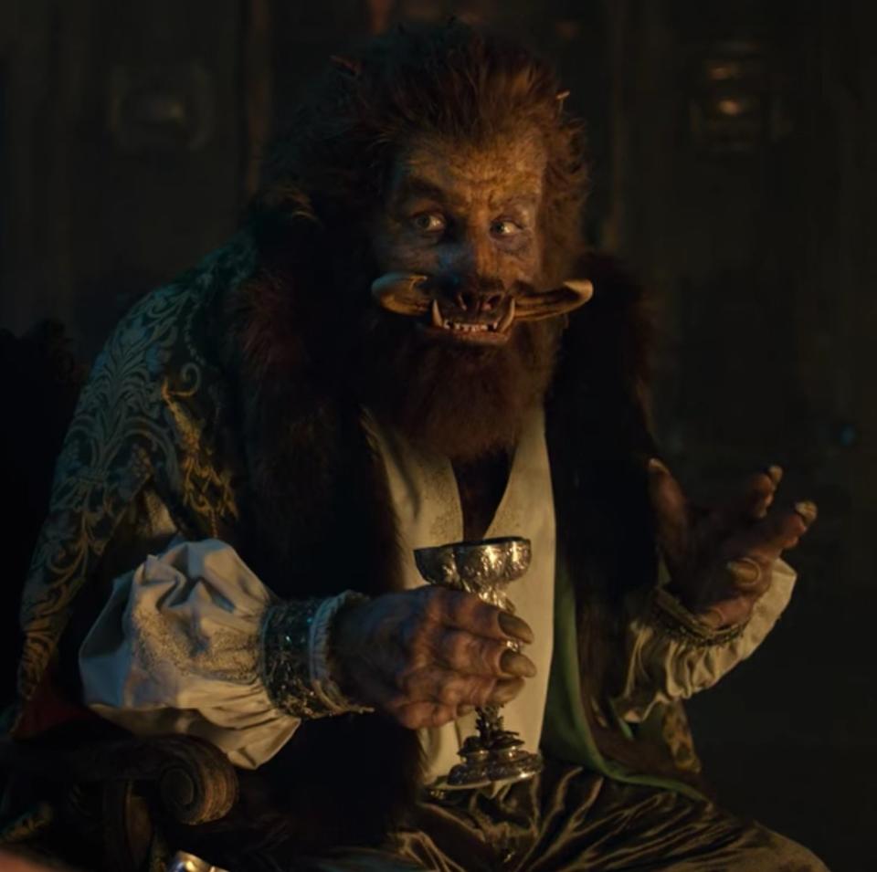 Kristofer Hivju as Nivellen sits and sips a drink in "The Witcher"