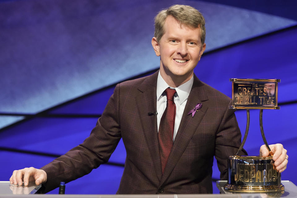 This image released by ABS shows contestant Ken Jennings with a trophy on "JEOPARDY! The Greatest of All Time." Jennings will be the first interim guest for the late Alex Trebek, and the show will try other guest hosts before naming a permanent replacement. (Eric McCandless/ABC via AP)