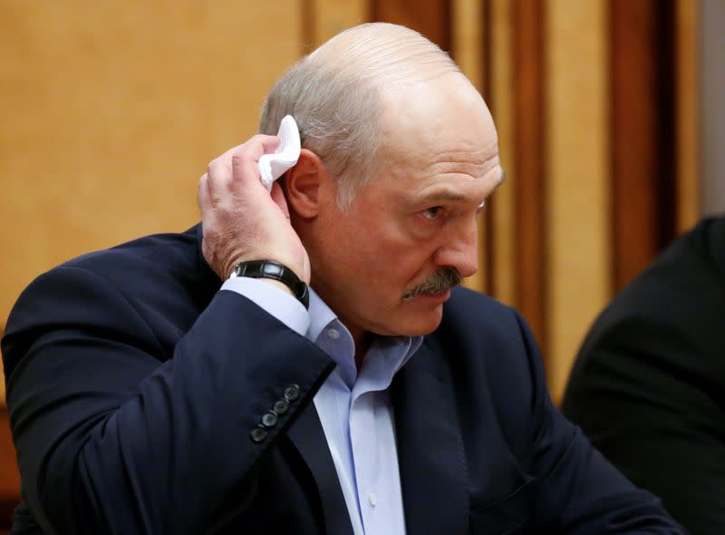 FILE PHOTO: Belarusian President Alexander Lukashenko listens to Russian President Vladimir Putin during their meeting in the Black sea resort of Sochi