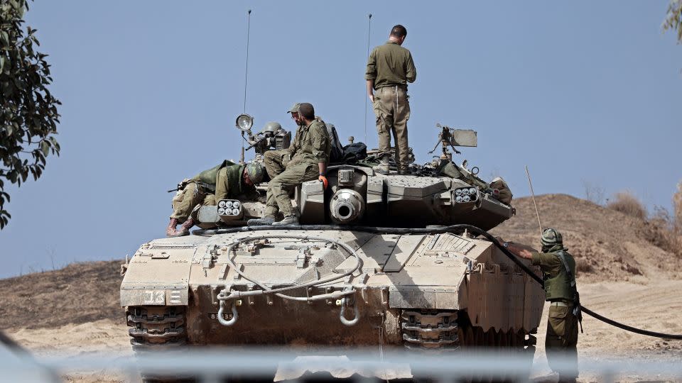 Israeli soldiers refuel their Merkava tank near the southern Israeli city of Sderot on Monday. - Thomas Coex/AFP/Getty Images