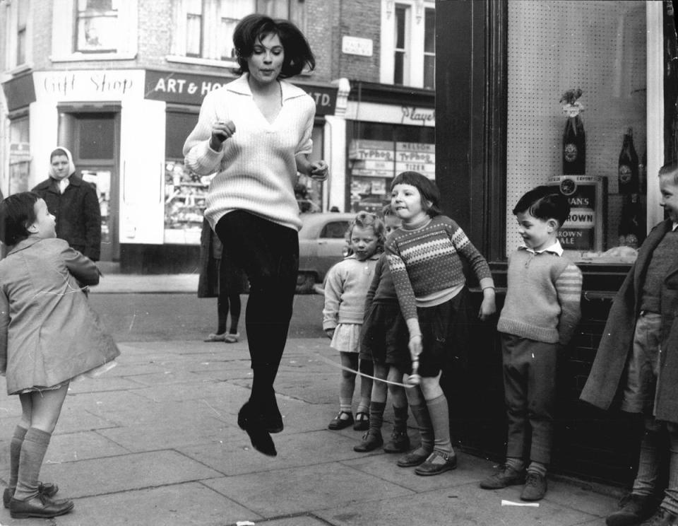 1962: Actress Kathleen Breck skips with children in Notting Hill. (Frank Hudson/Associated Newspapers)