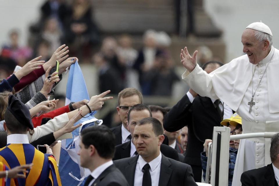 Pope Francis waves to faithful as he arrives in St. Peter's Square at the Vatican for his weekly general audience, Wednesday, March 22, 2017. (AP Photo/Gregorio Borgia)