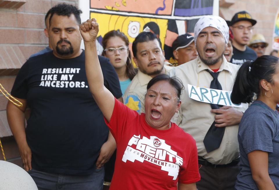 Immigration activists protest against the Maricopa County Sheriff and Immigration and Customs Enforcement at the county jail in an ongoing effort to get immigration authorities out in front of 4th Avenue Jail, Wednesday, Aug. 22, 2018, in Phoenix. (AP Photo/Ross D. Franklin)