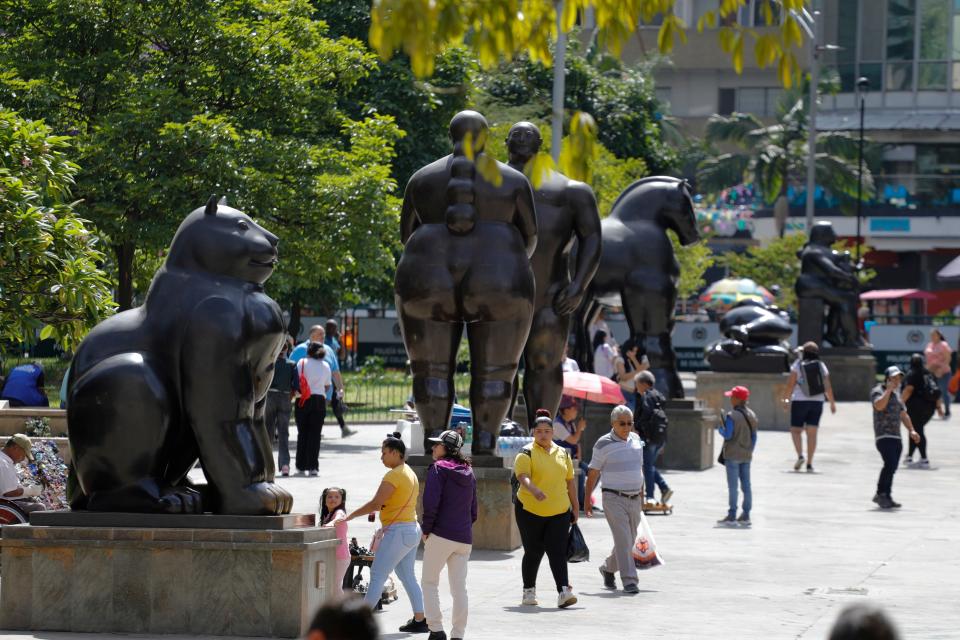 People walk past sculptures by Colombian artist Fernando Botero a Botero Park in Medellin, Colombia, on Sept. 15, 2023.