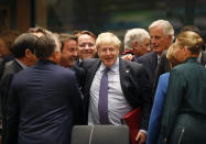 British Prime Minister Boris Johnson, center, is greeted by Luxembourg's Prime Minister Xavier Bettel, center left, during a round table meeting at an EU summit in Brussels, Thursday, Oct. 17, 2019. Britain and the European Union reached a new tentative Brexit deal on Thursday, hoping to finally escape the acrimony, divisions and frustration of their three-year divorce battle. (AP Photo/Frank Augstein)