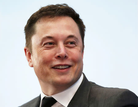 FILE PHOTO: Tesla Chief Executive Elon Musk smiles as he attends a forum on startups in Hong Kong, China January 26, 2016. REUTERS/Bobby Yip/File Photo