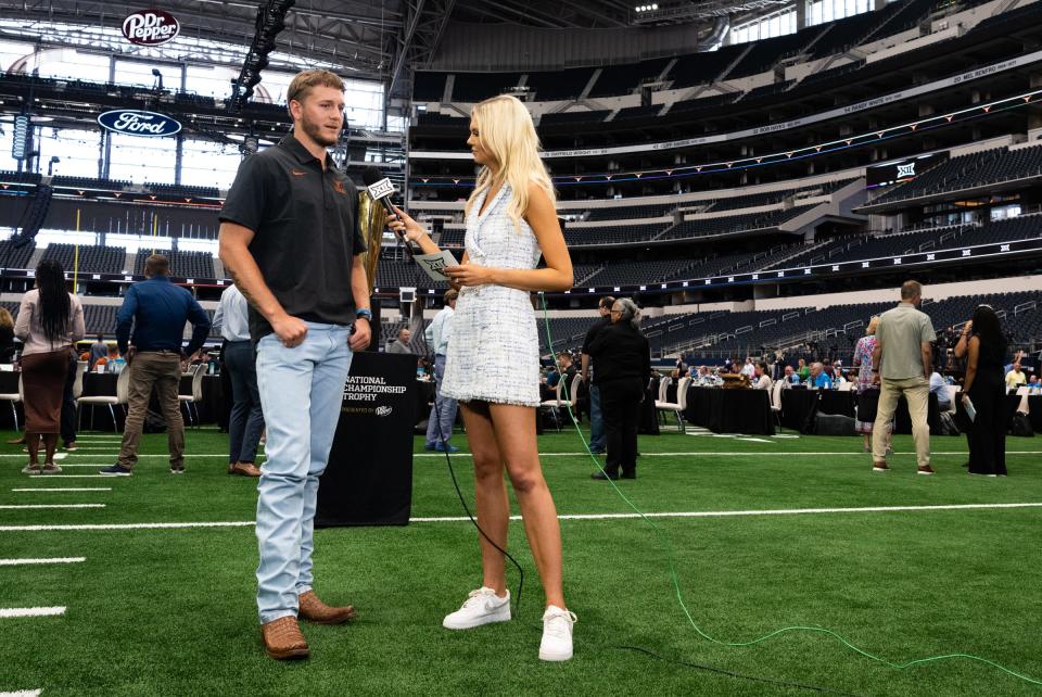 Texas quarterback Quinn Ewers speaks to ESPN's Hannah Wing during the first day of Big 12 media days on Wednesday at AT&T Stadium in Arlington. Ewers is entering his second season as the Longhorns' starter.