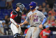 New York Mets' Pete Alonso (20) scores in front of Miami Marlins catcher Nick Fortes during the ninth inning of a baseball game, Saturday, April 1, 2023, in Miami. (AP Photo/Michael Laughlin)