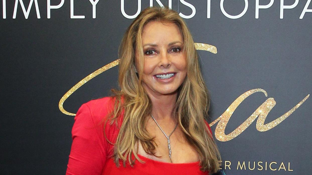 Carol Vorderman in a belted red dress