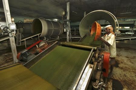 An employee works inside a tea producing factory at the Amchong tea estate in Assam, July 11, 2012. REUTERS/Utpal Baruah