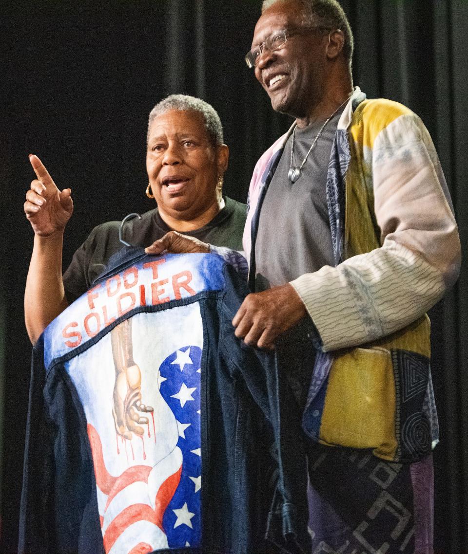 JoAnne Bland presents Albert Southall with a foot soldier jacket during the Foot Soldiers Breakfast held at Selma High School in Selma, Ala., on Saturday, March 4, 2023.