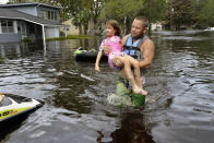 <p>Tommy Nevitt carries Miranda Abbott, 6, through floodwater caused by Hurricane Irma on the west side of Jacksonville, Fla., Sept. 11 2017. (Photo: Dede Smith/The Florida Times-Union via AP) </p>