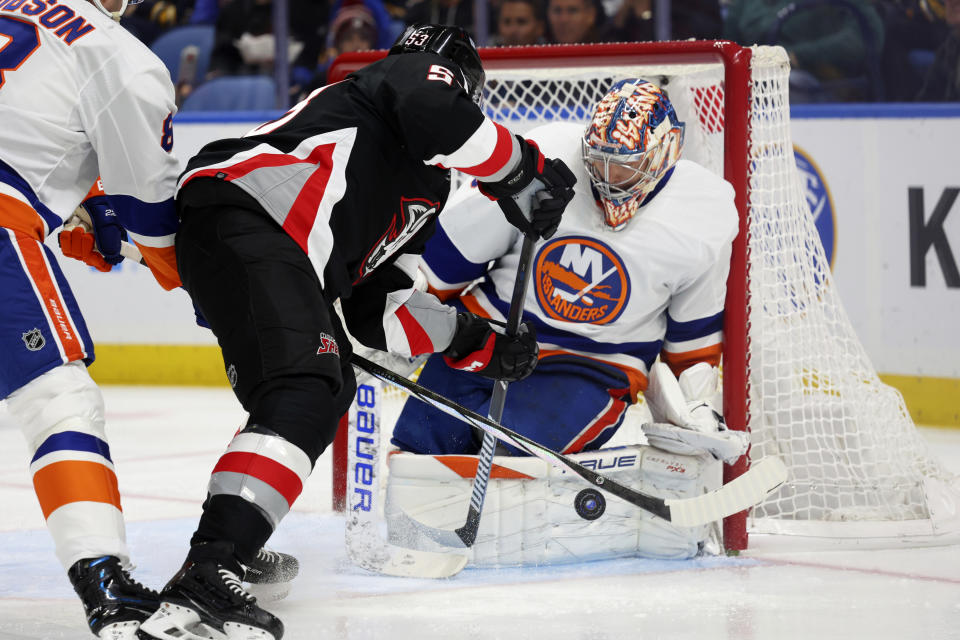 Buffalo Sabres left wing Jeff Skinner, center, is stopped by New York Islanders goaltender Semyon Varlamov, right, during the first period of an NHL hockey game Saturday, Oct. 21, 2023, in Buffalo, N.Y. (AP Photo/Jeffrey T. Barnes)