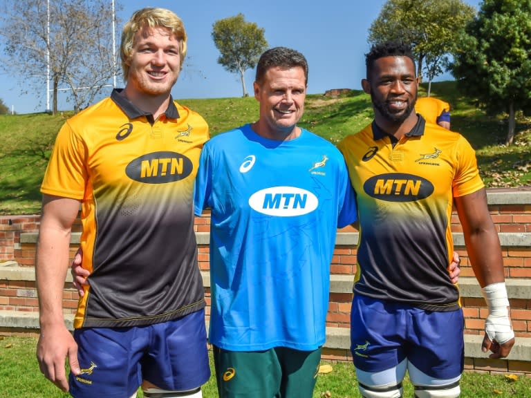 (From L) The Springboks' lock Pieter-Steph du Toit, head coach Rassie Erasmus and flanker Siya Kolisi pose for a photo ahead of a training session in Johannesburg, on May 28, 2018