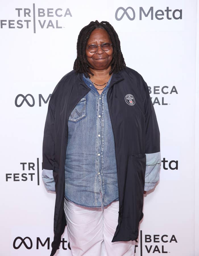 A closeup of Whoopi wearing a denim shirt and pants