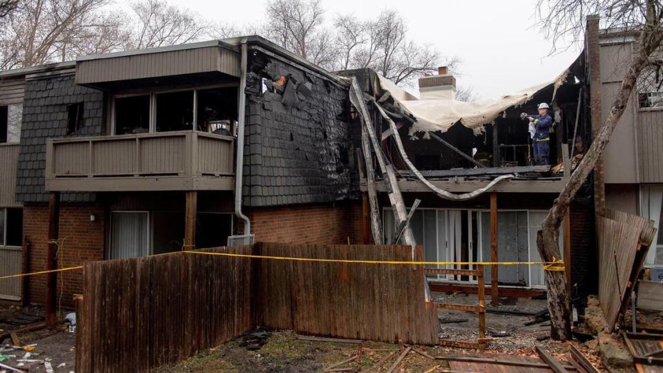 An Overland Park fire investigator documents an apartment that was destroyed in a fire at the Meadowlark Hill Apartments on Thursday, Dec. 8, 2022, in Overland Park, Kan.