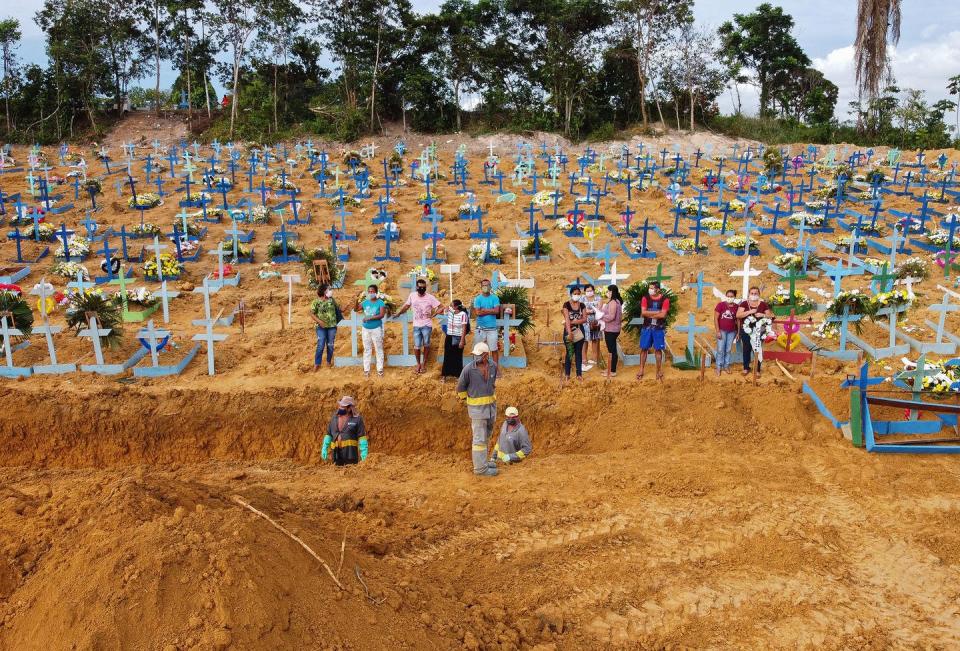 <span class="caption">A burial takes place at a cemetery in Manaus, Brazil. The grave area hosts suspected and confirmed victims of the pandemic.</span> <span class="attribution"><a class="link " href="https://www.gettyimages.com/detail/news-photo/aerial-picture-showing-a-burial-taking-place-at-an-area-news-photo/1210677694?adppopup=true" rel="nofollow noopener" target="_blank" data-ylk="slk:Getty Images / Michael Dantas;elm:context_link;itc:0;sec:content-canvas">Getty Images / Michael Dantas</a></span>