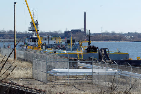 Several pipelines, foreground, connecting the Eco Energy storage and transfer facilities, not seen in this view, lead to a marine loading dock on the Delaware River where a barge is loading, photographed in Philadelphia, Pennsylvania, U.S. on February 4, 2017. Picture taken February 4, 2017. REUTERS/Tom Mihalek