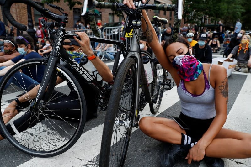 People hold a vigil near Gracie Mansion as protests against the death in Minneapolis police custody of George Floyd continue, in New York City