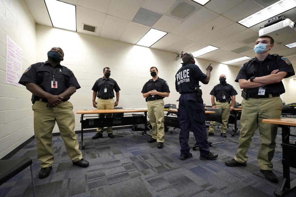 In this Sept. 9, 2020, photo Officer Edward Gillespie, third from right, leads a class in procedural justice with Baltimore Police Academy cadets in Baltimore. (AP Photo/Julio Cortez)