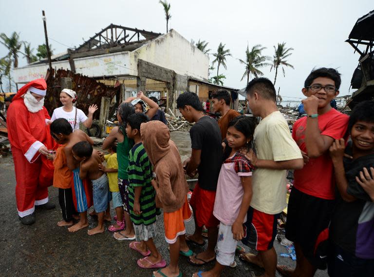 A volunteer dressed as Santa Claus distributes gifts to survivors of Super Typhoon Haiyan in Tacloban, Philippines on December 25, 2013