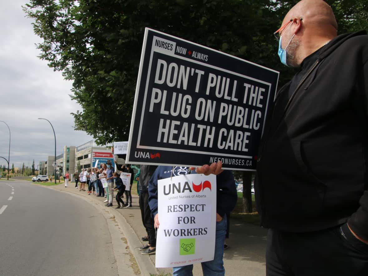 Some campaigns, like this Calgary protest in August 2021, have raised concerns about the privatization of Alberta's health-care system. Critics say Alberta hospitals and health centres are becoming too dependent on private staffing agencies to stay functional. (Rachel Maclean/CBC - image credit)