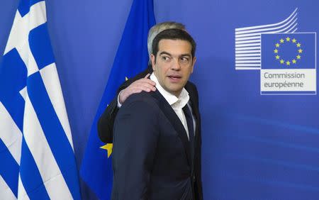 Greek Prime Minister Alexis Tsipras (front) is welcomed by European Commission President Jean Claude Juncker for a meeting ahead of a Eurozone emergency summit on Greece in Brussels, Belgium in this June 22, 2015 file photo. REUTERS/Yves Herman/Files