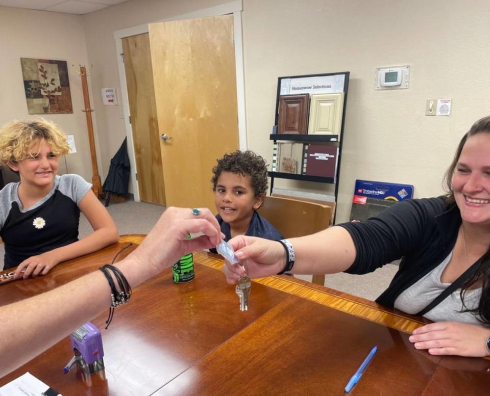 Heather Witt, alongside her two children, gets the keys to their new home.