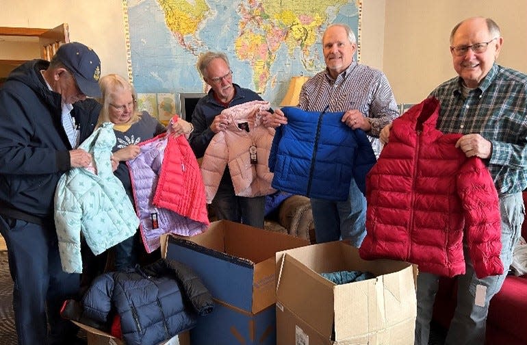 Sheboygan Optimist Club members Roger Beaumont (from left), Laurel Schirmer, Jim Kaufman, Scott Stangel Dennis Morrell unpack recently purchased coats for its 100th anniversary 100-coat drive for local youth.