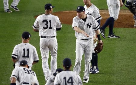 Oct 16, 2017; Bronx, NY, USA; New York Yankees third baseman Todd Frazier (29) celebrates with New York Yankees center fielder Aaron Hicks (31) after beating the Houston Astros during game three of the 2017 ALCS playoff baseball series at Yankee Stadium. Mandatory Credit: Adam Hunger-USA TODAY Sports