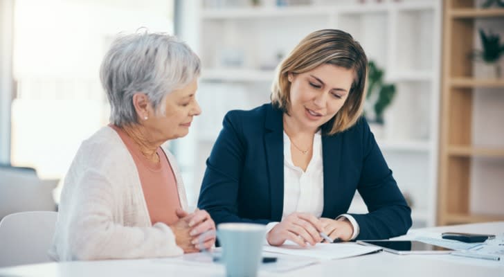 A financial advisor goes over retirement investments with a client. 