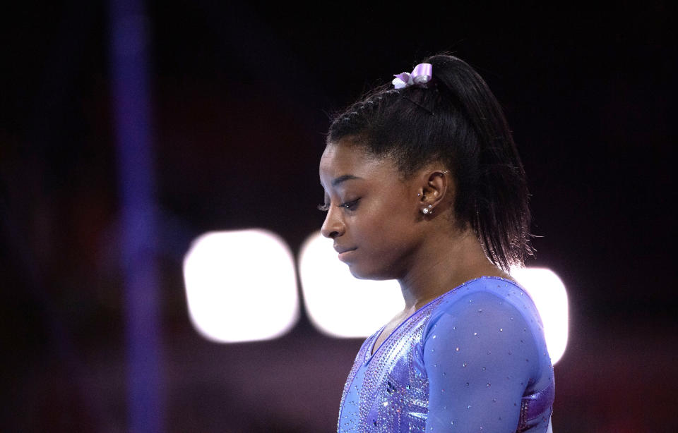 Simone Biles prepares for her routine on the uneven bars