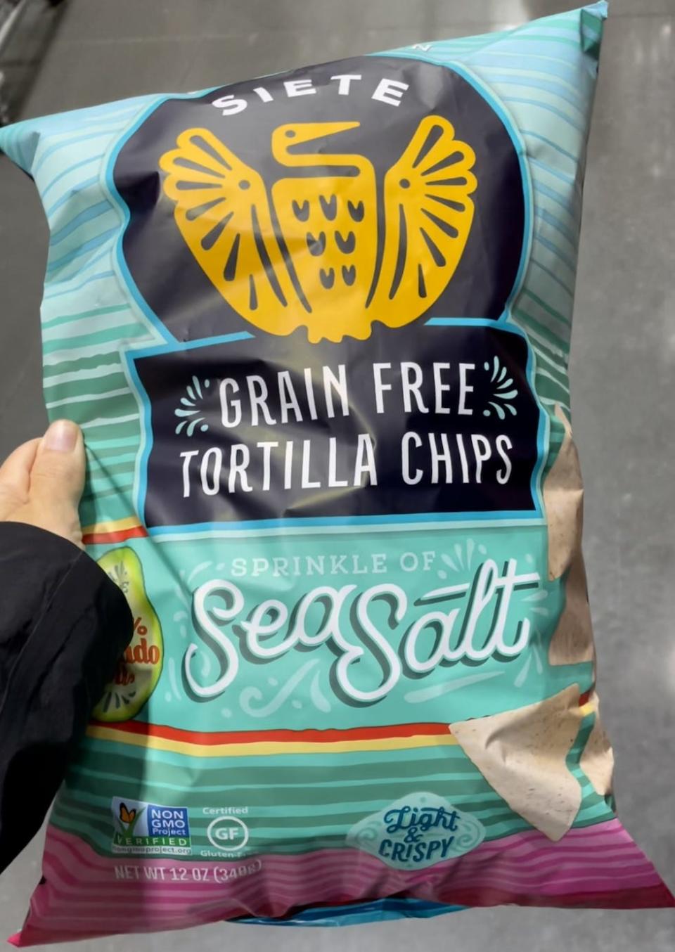 hand holding bag of tortilla chips at costco