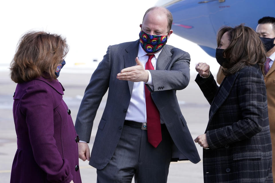 Vice President Kamala Harris are greeted by Colorado Gov. Jared Polis and Colorado Lt. Gov. Dianne Primavera on arrival in Denver, Tuesday March 16, 2021. (AP Photo/Jacquelyn Martin)