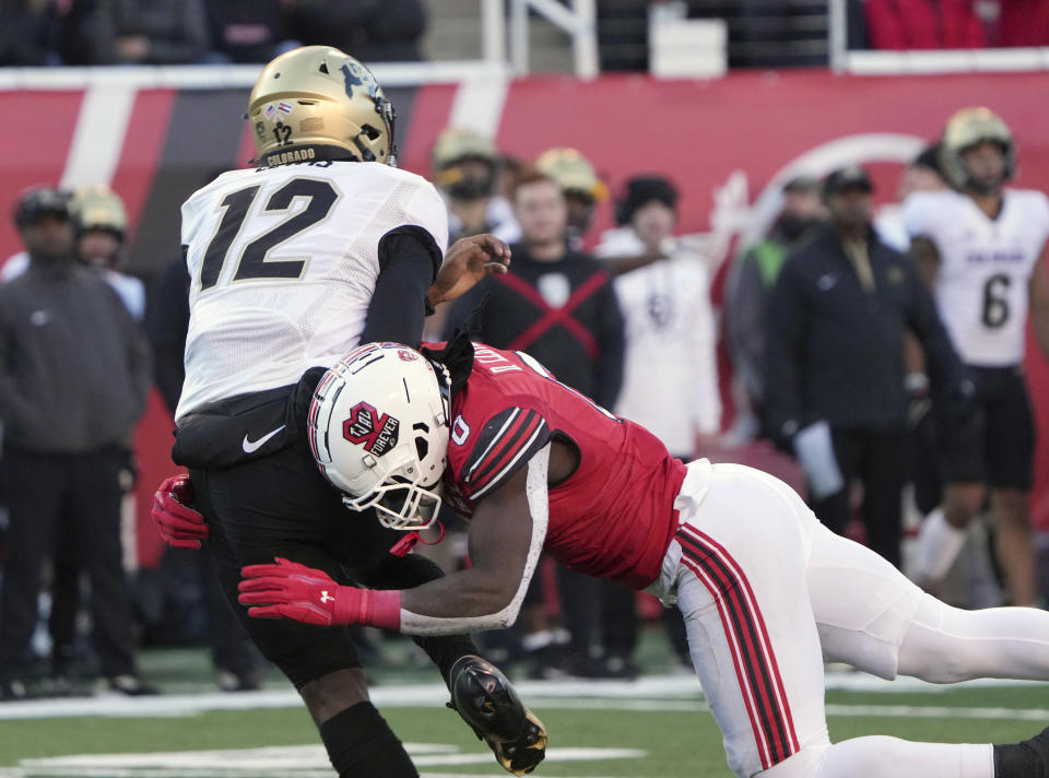 Colorado quarterback Brendon Lewis (12) is hit by Utah linebacker Devin Lloyd (0) in the second half of an NCAA college football game Friday, Nov. 26, 2021, in Salt Lake City. (AP Photo/George Frey)