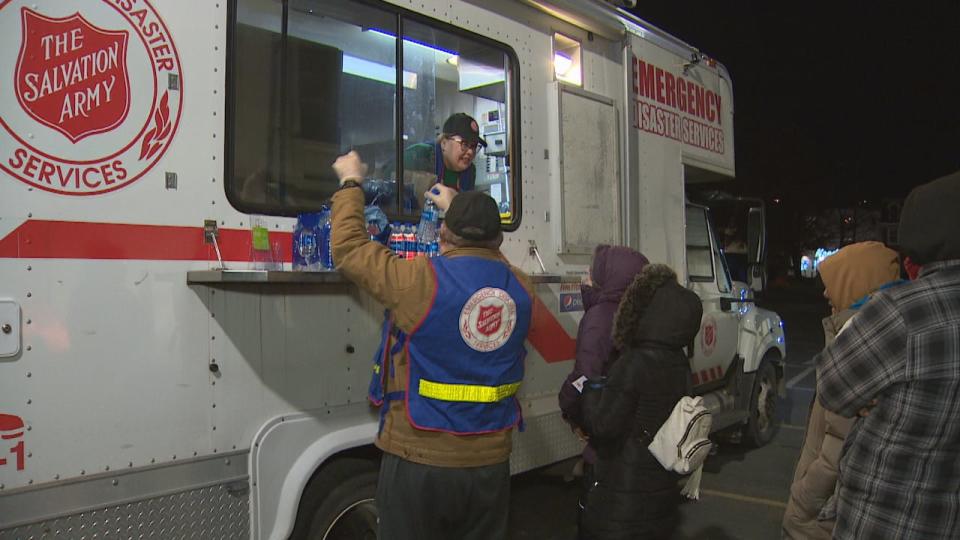 Volunteers with The Salvation Army gave out water and hot meals of macaroni and cheese at the tent encampment in Bannerman Park on Monday evening.