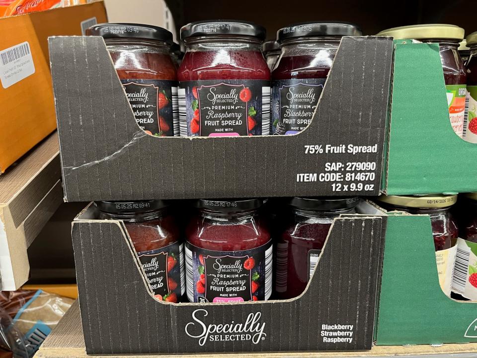 Jars of raspberry fruit spread in boxes at Aldi.