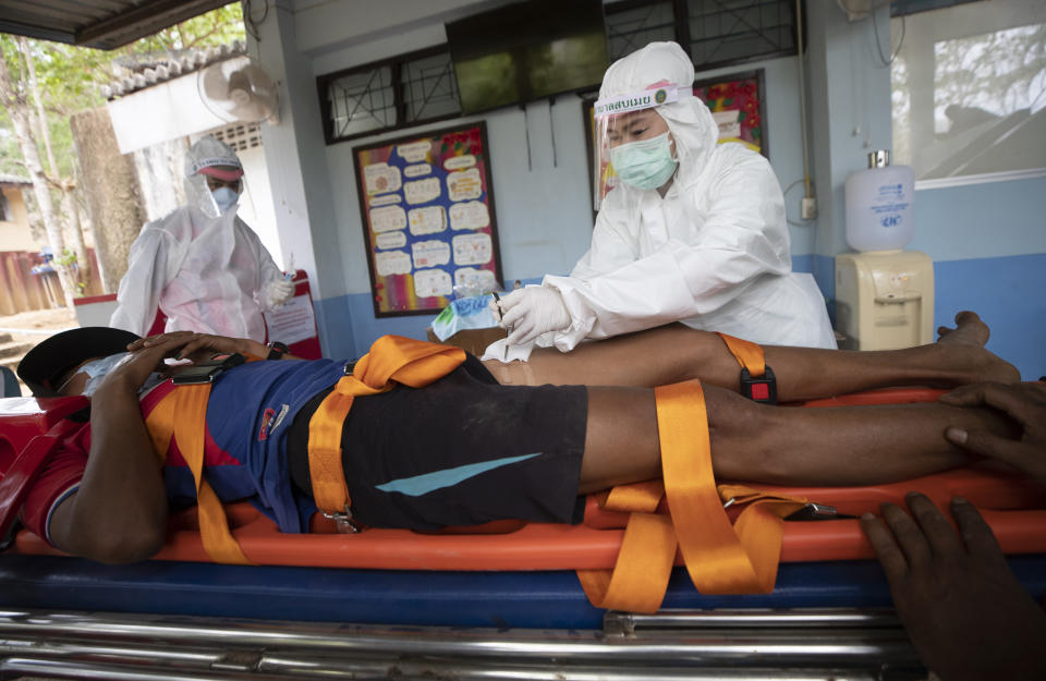 Medical workers attend to an injured Karen villager from Myanmar who crossed Salawin river on a boat, at Ban Mae Sam Laep Health Center, Mae Hong Son province, northern Thailand on Tuesday March 30, 2021. The weekend strikes by the Myanmar military, which sent ethnic Karen people seeking safety in Thailand, represented another escalation in the violent crackdown by Myanmar’s junta on protests of its Feb. 1 takeover.(AP Photo/Sakchai Lalit)