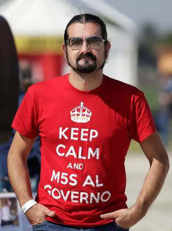 A 5-Star movement supporter wears a t-shirt reading " Keep calm and 5-Star to lead the government" during a gathering in Rimini, Italy, September 23, 2017. REUTERS/Max Rossi