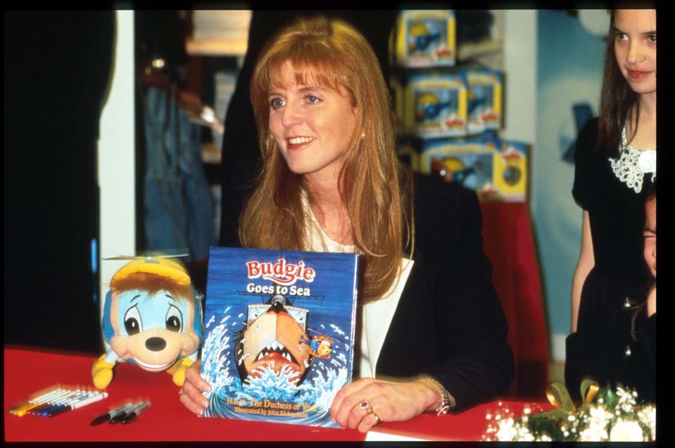 246730 02: Duchess of York Sarah Ferguson holds a copy of her book 