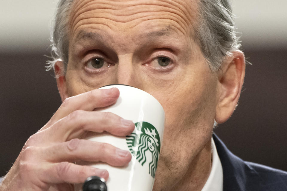 Former Starbucks CEO Howard Schultz drinks from a Starbucks mug as he testifies before the Senate Health, Education, Labor and Pensions committee, Wednesday, March 29, 2023, on Capitol Hill in Washington. (AP Photo/Jacquelyn Martin)