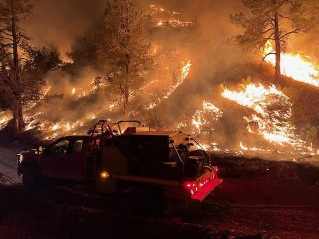 Crews from the Yoder Volunteer Fire Department out of Wyoming work on the Black Fire in the Gila National Forest May 30, 2022.