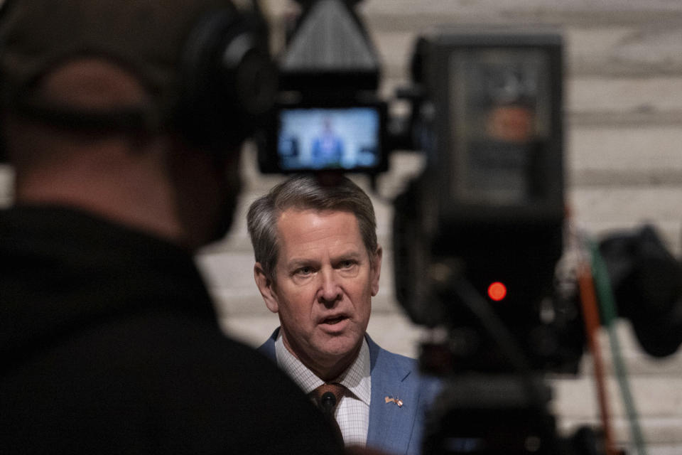 Georgia Gov. Brian Kemp, center, holds a press conference Wednesday evening, Jan. 6, 2021, at the Georgia State Capitol in Atlanta, to condemn the breach of the U.S. Capitol. (AP Photo/Ben Gray)